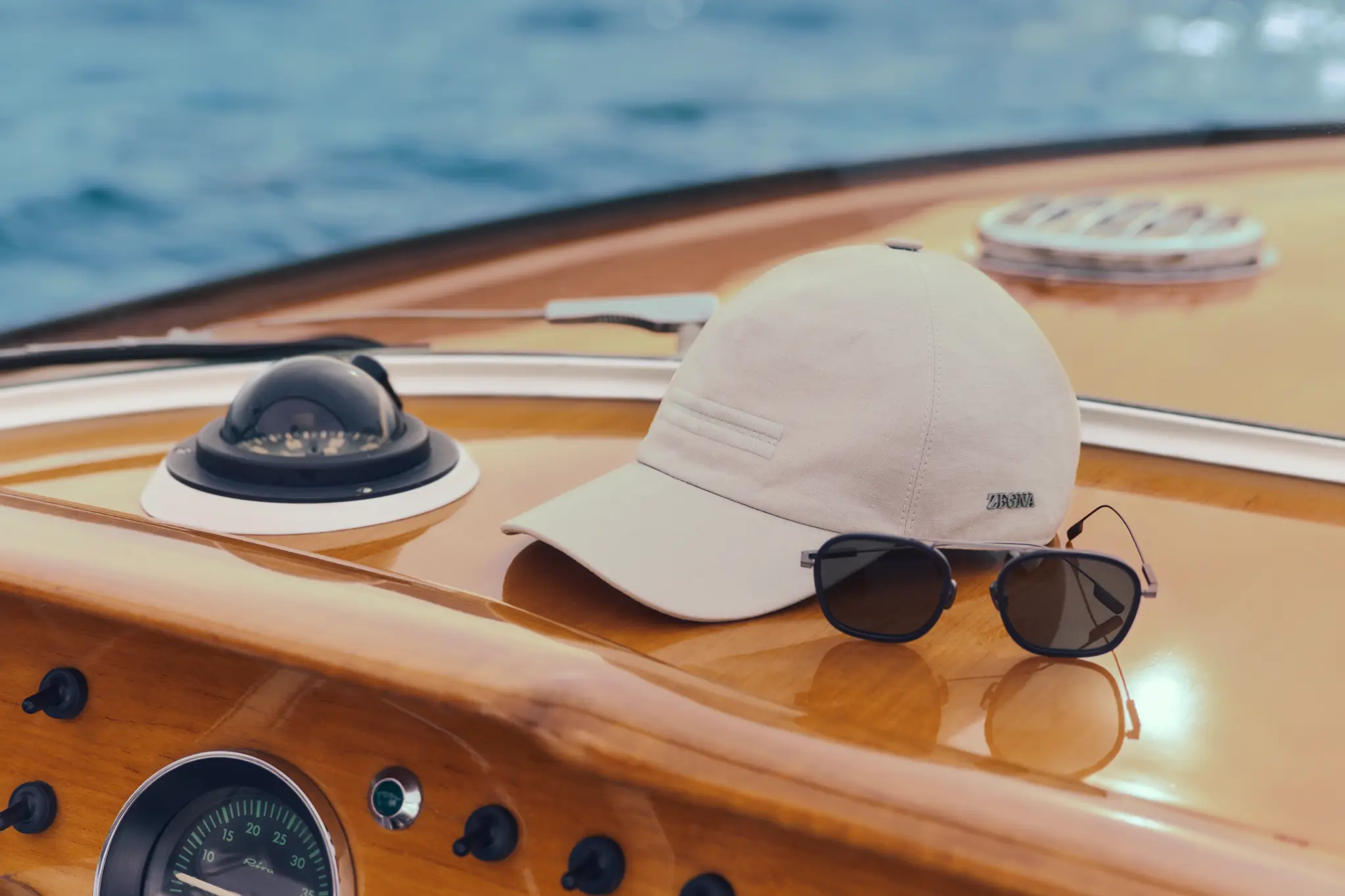 ZEGNA sunglasses and baseball cap from the Spring Summer 2026 collection with boat background