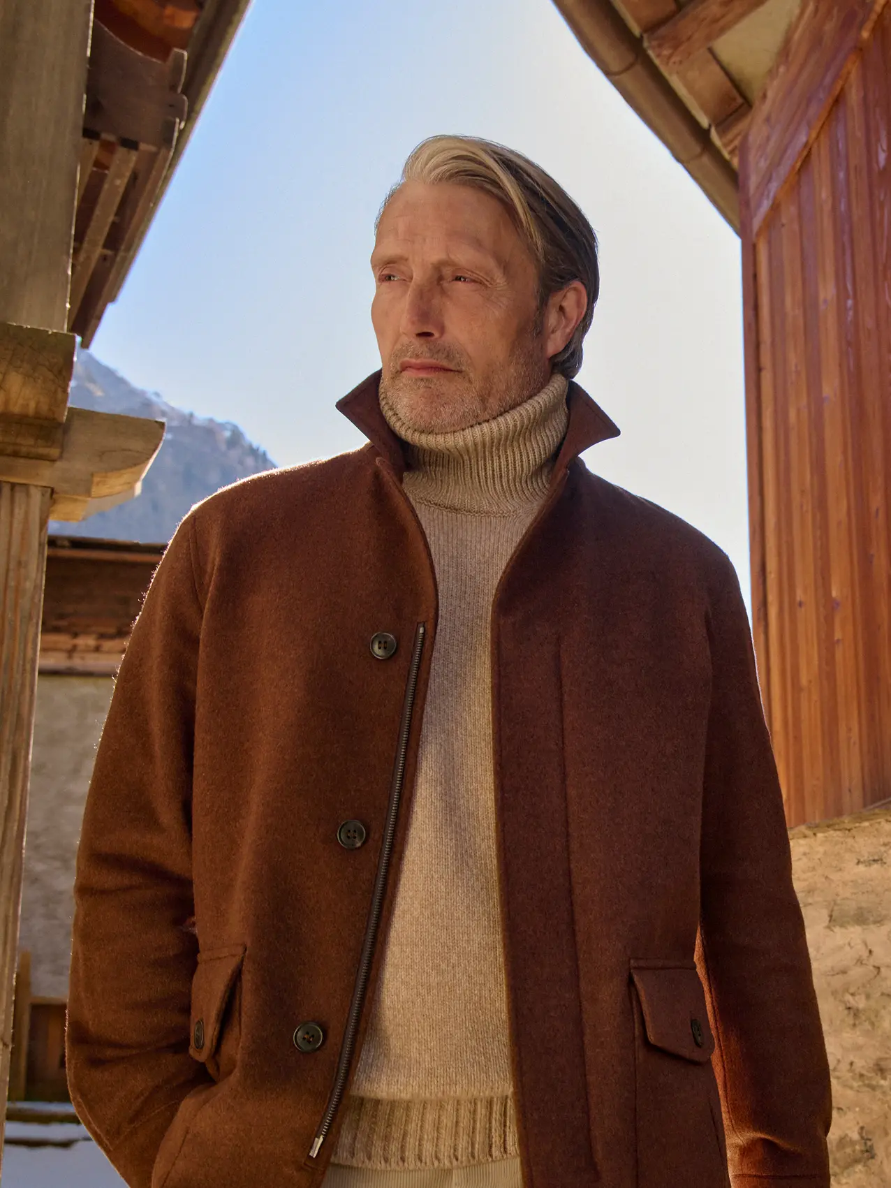 Mads Mikkelsen wearing the new Falcon jacket in rust-brown Oasi Cashmere Elements with button and zip closure over a cream turtleneck from the ZEGNA Fall/Winter 2026 collection.