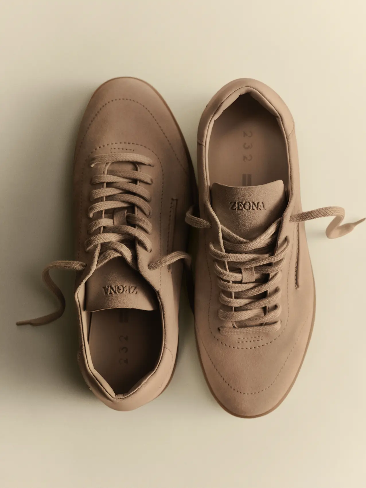 Top view of the ZEGNA 232 sneakers in Dark Beige suede, from FW26 collection.