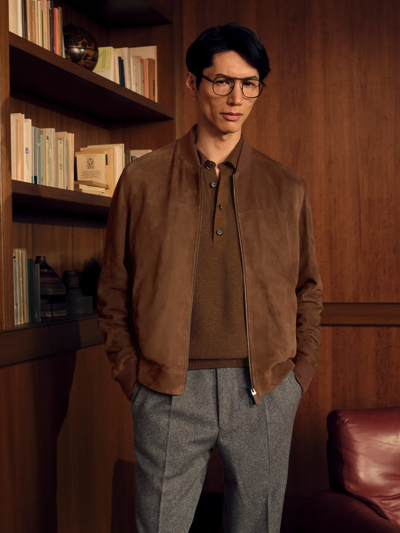 Detail of the Suede Bomber in brown layered over the Oasi Cashmere Polo in brown, styled with Wool and Cashmere Pants in light taupe mouliné herringbone, from the ZEGNA Fall/Winter 2026 collection.