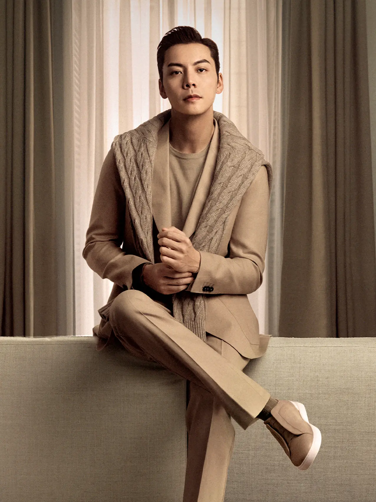 William Chan wearing a beige outfit from the ZEGNA Spring Summer 2026 collection featuring a knitwear and Triple Stitch sneakers.