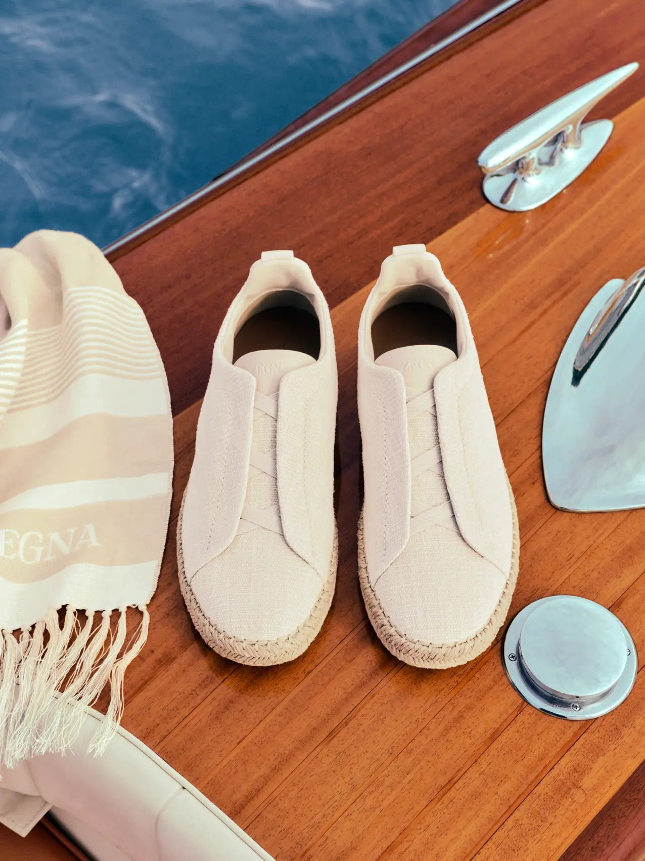 ZEGNA Triple Stitch linen espadrillas and beach towel from the Spring Summer 2026 collection with boat background