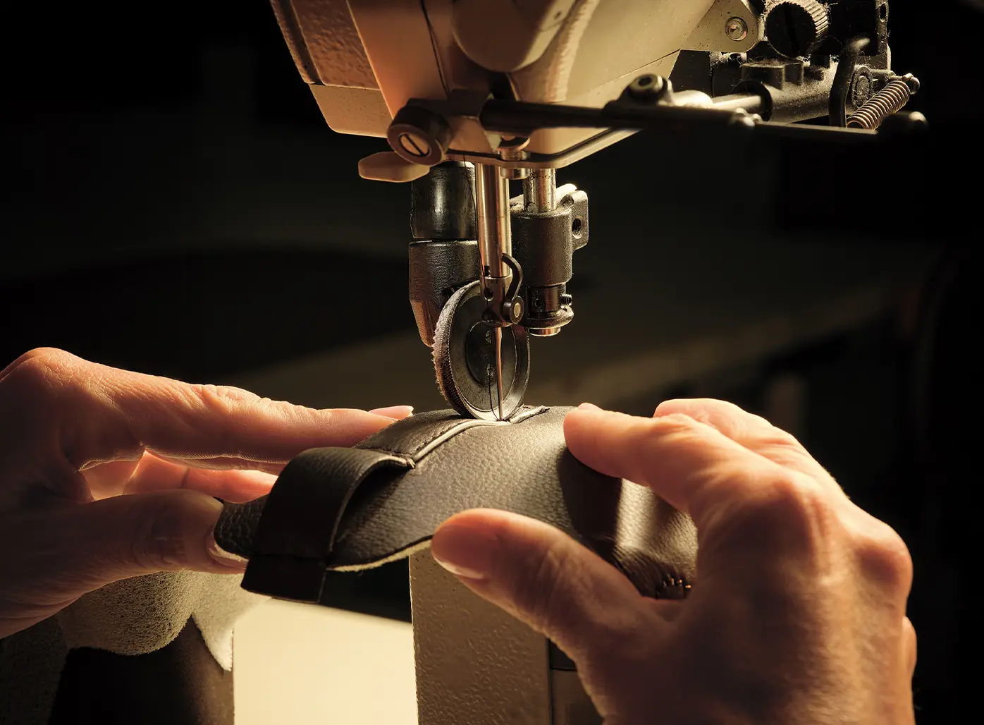 Image of a ZEGNA artisan sewing together pieces of leather to create Triple Stitch™ SECONDSKIN sneakers.