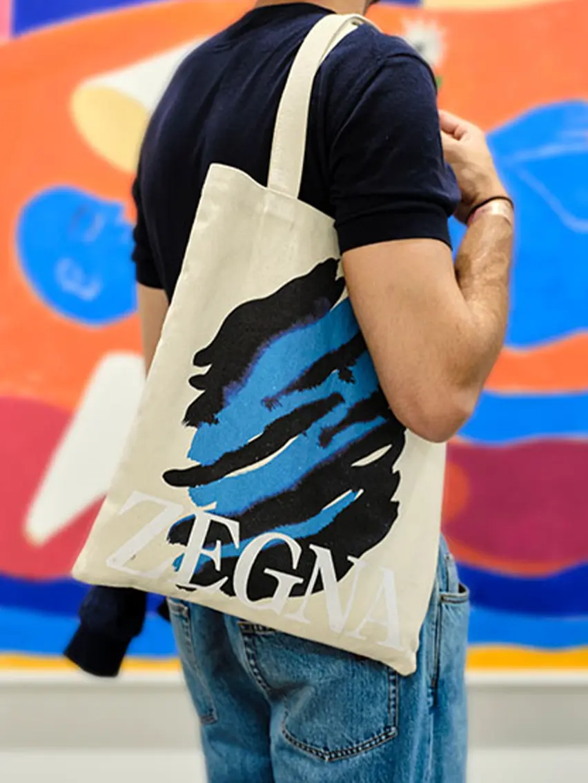 ZEGNA Art Basel tote bag carried by a visitor at the event.