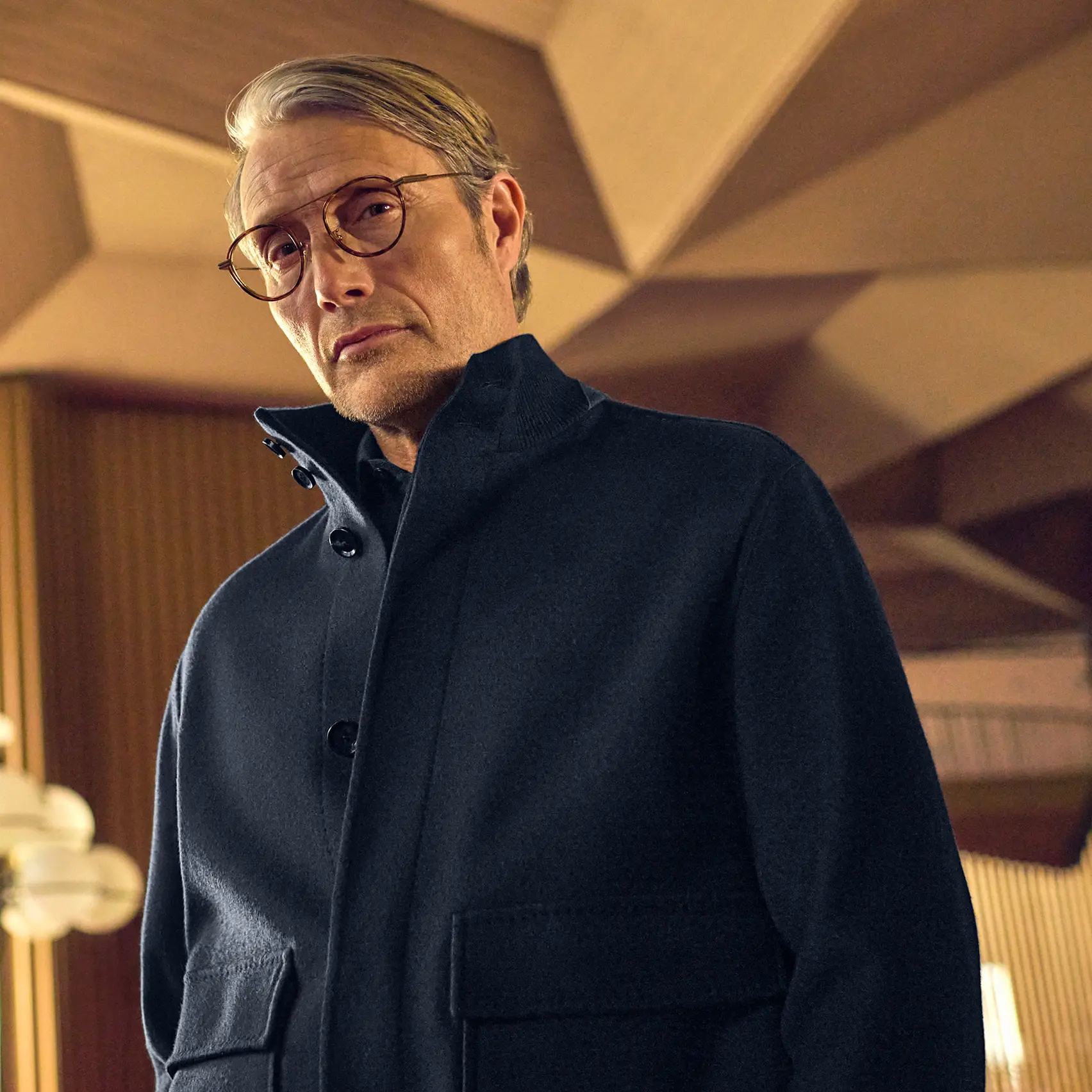 Mads Mikkelsen in a refined monochrome casual look, photographed at Teatro Regio for the ZEGNA FW25 collection.