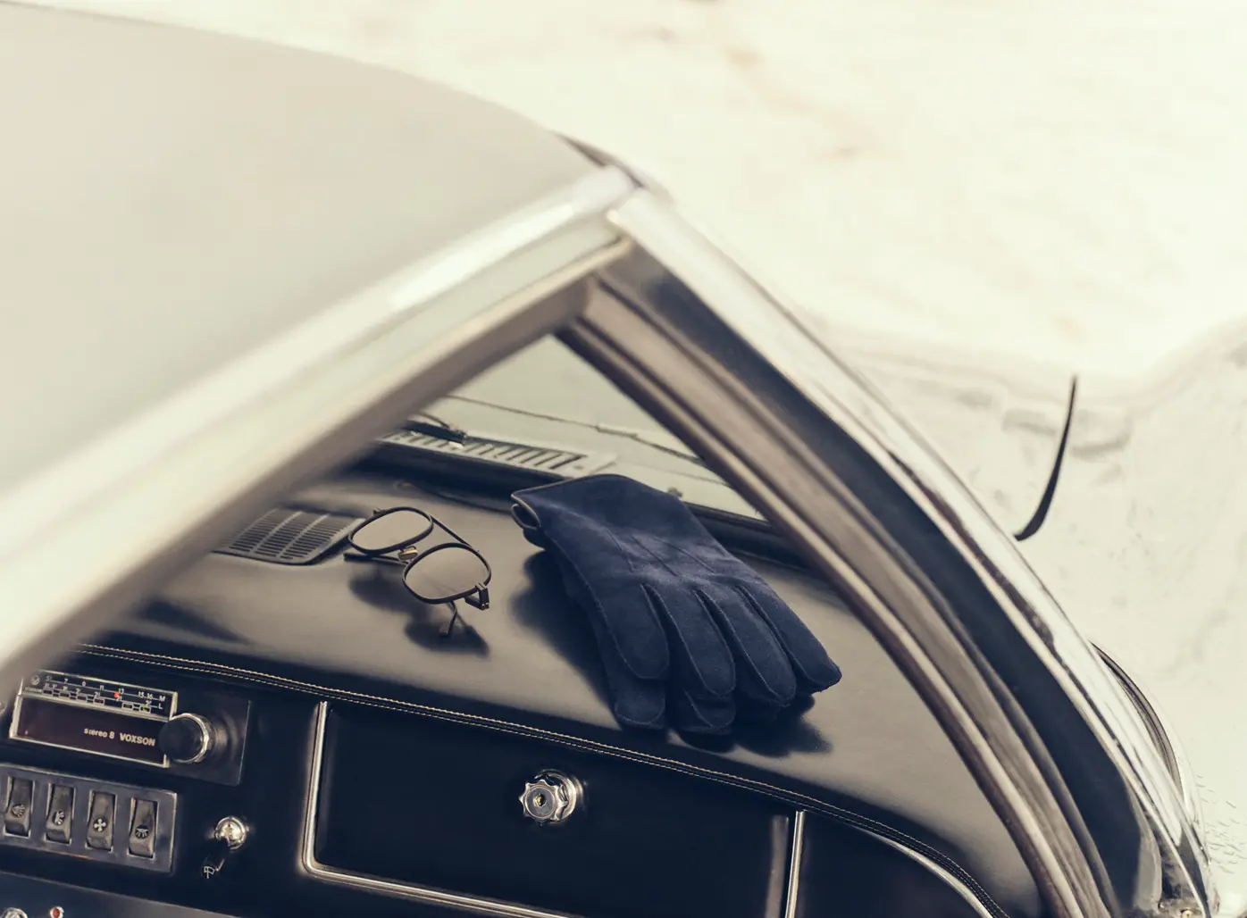 Close-up of ZEGNA gloves inside a sports car, Fall Winter 2025 collection.