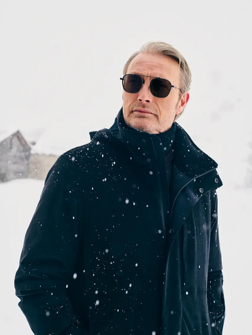 Mads Mikkelsen wearing a ZEGNA winter look featuring a ski suit.