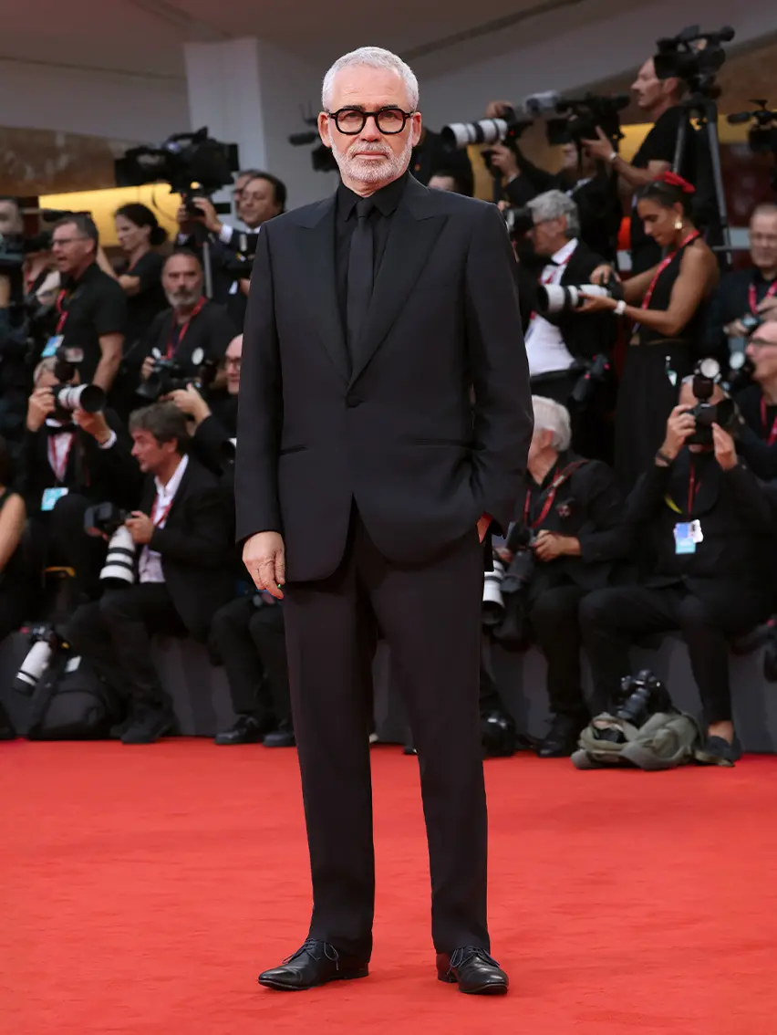 Stéphane Brizé wearing a ZEGNA tuxedo on the red carpet at the Venice Film Festival 2025.