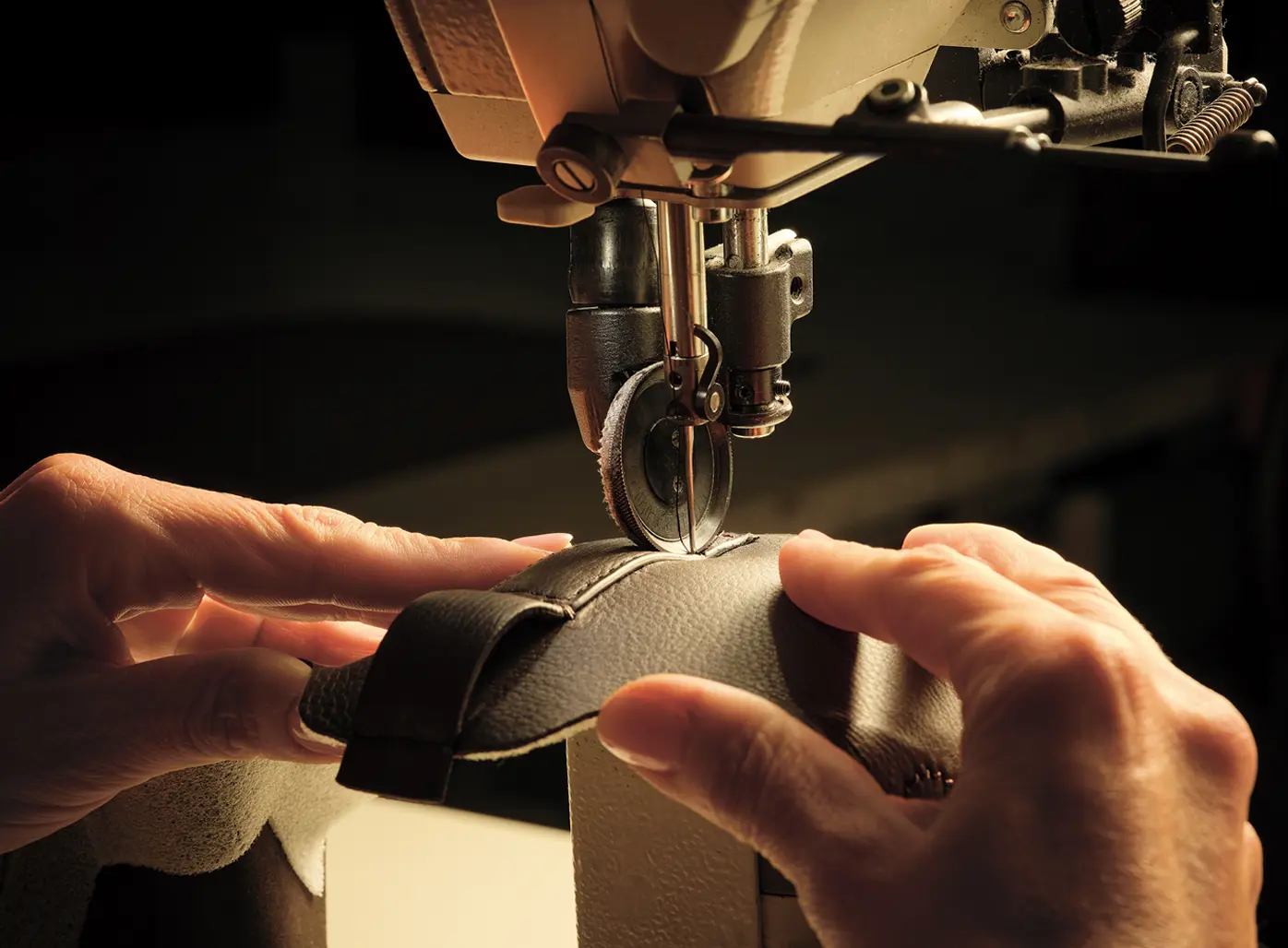 Image of a ZEGNA artisan sewing together pieces of leather to create Triple Stitch™ SECONDSKIN sneakers.