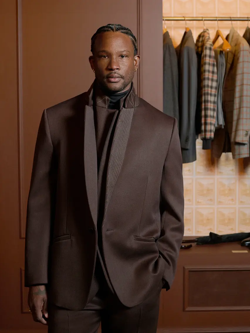 Akinola Davies wearing an elegant tailored look at the ZEGNA Winter Fashion Show 2026.