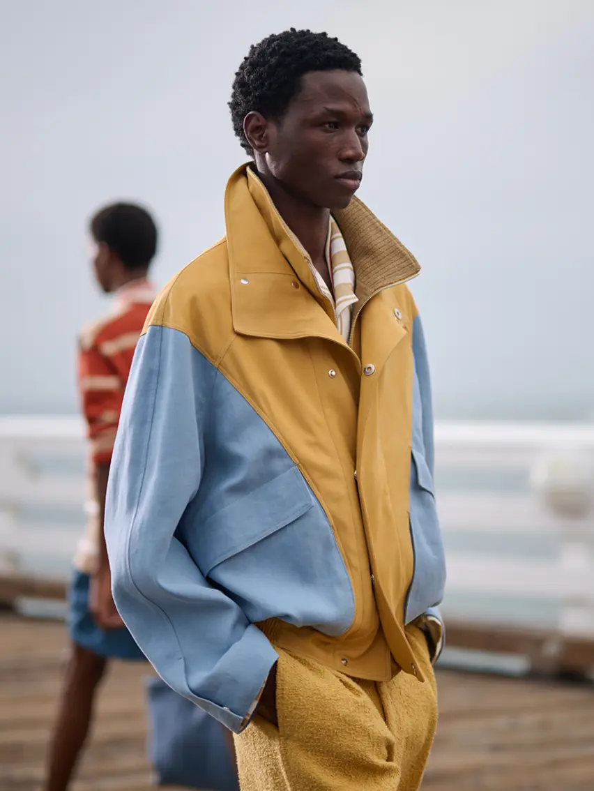 Model on the runway at ZEGNA’s Spring/Summer 2027 Fashion Show in LA wearing a blue and yellow jacket.