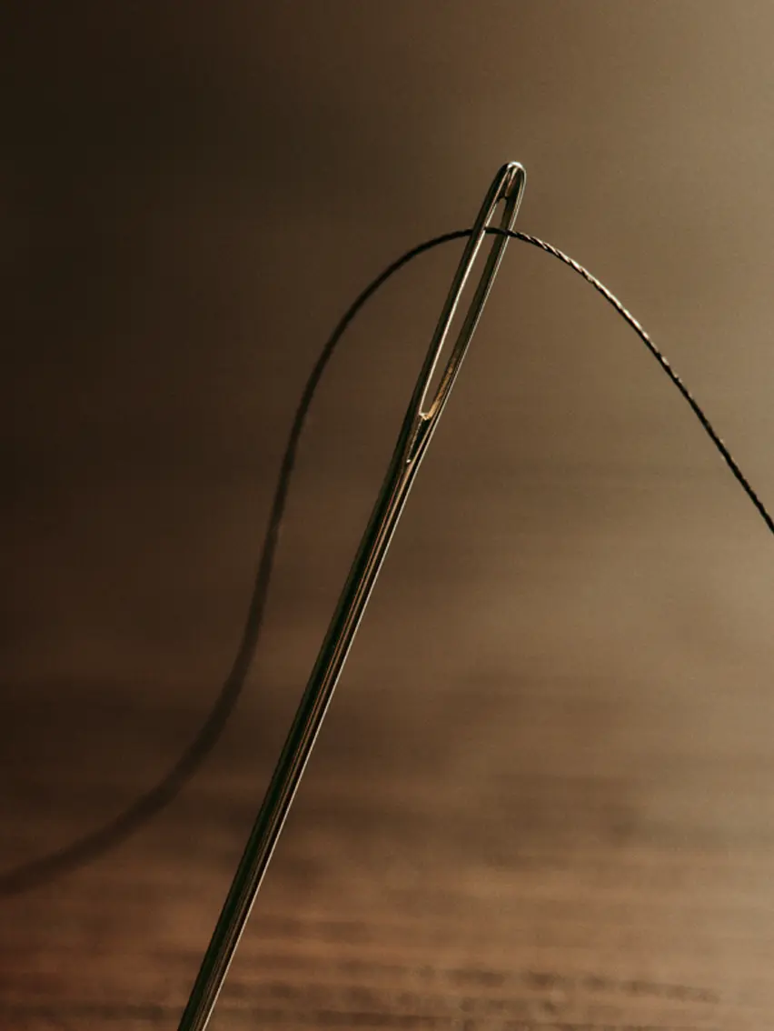 Close up of a tailoring needle and thread.