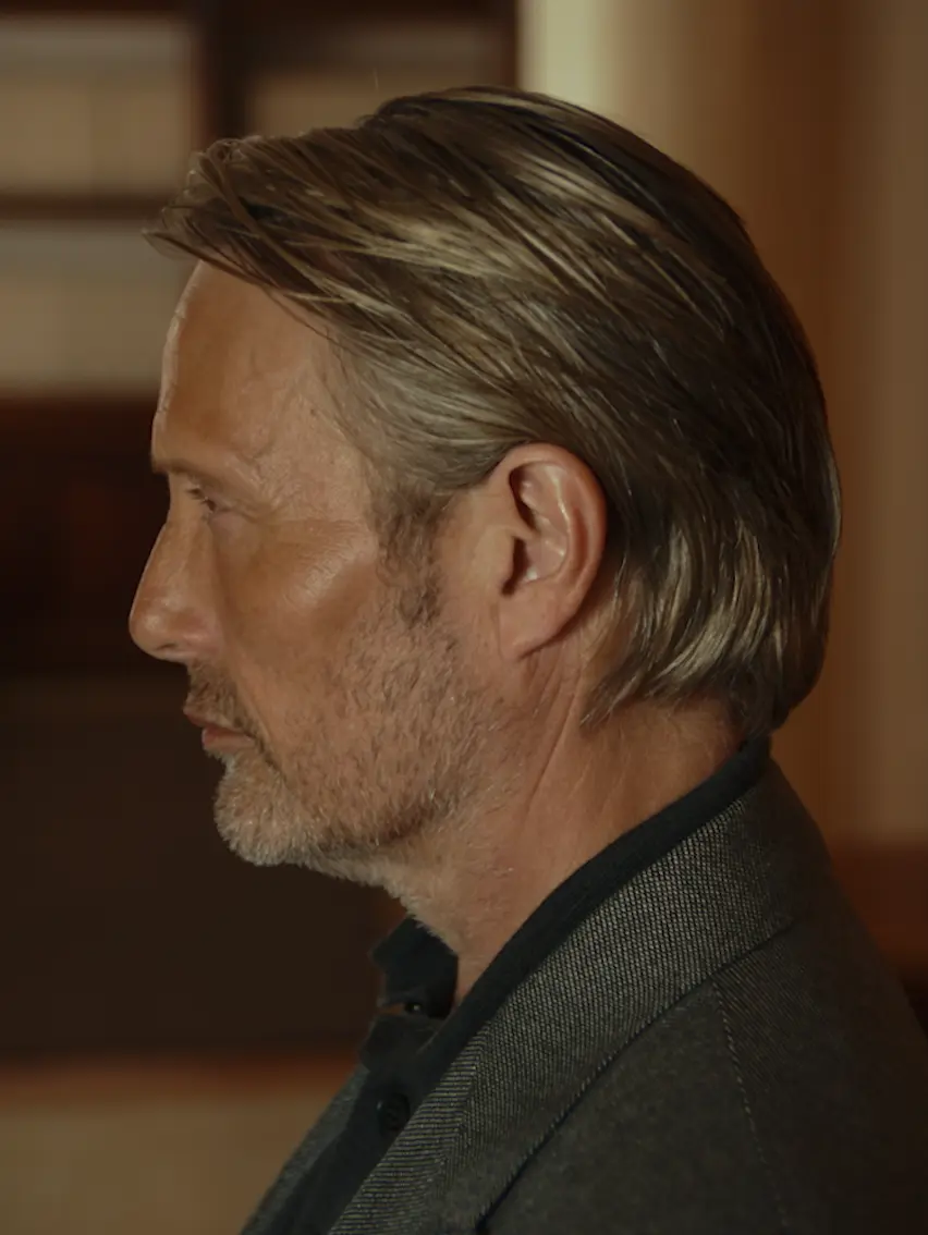 Profile portrait of Mads Mikkelsen during a tailoring fitting at a ZEGNA atelier.