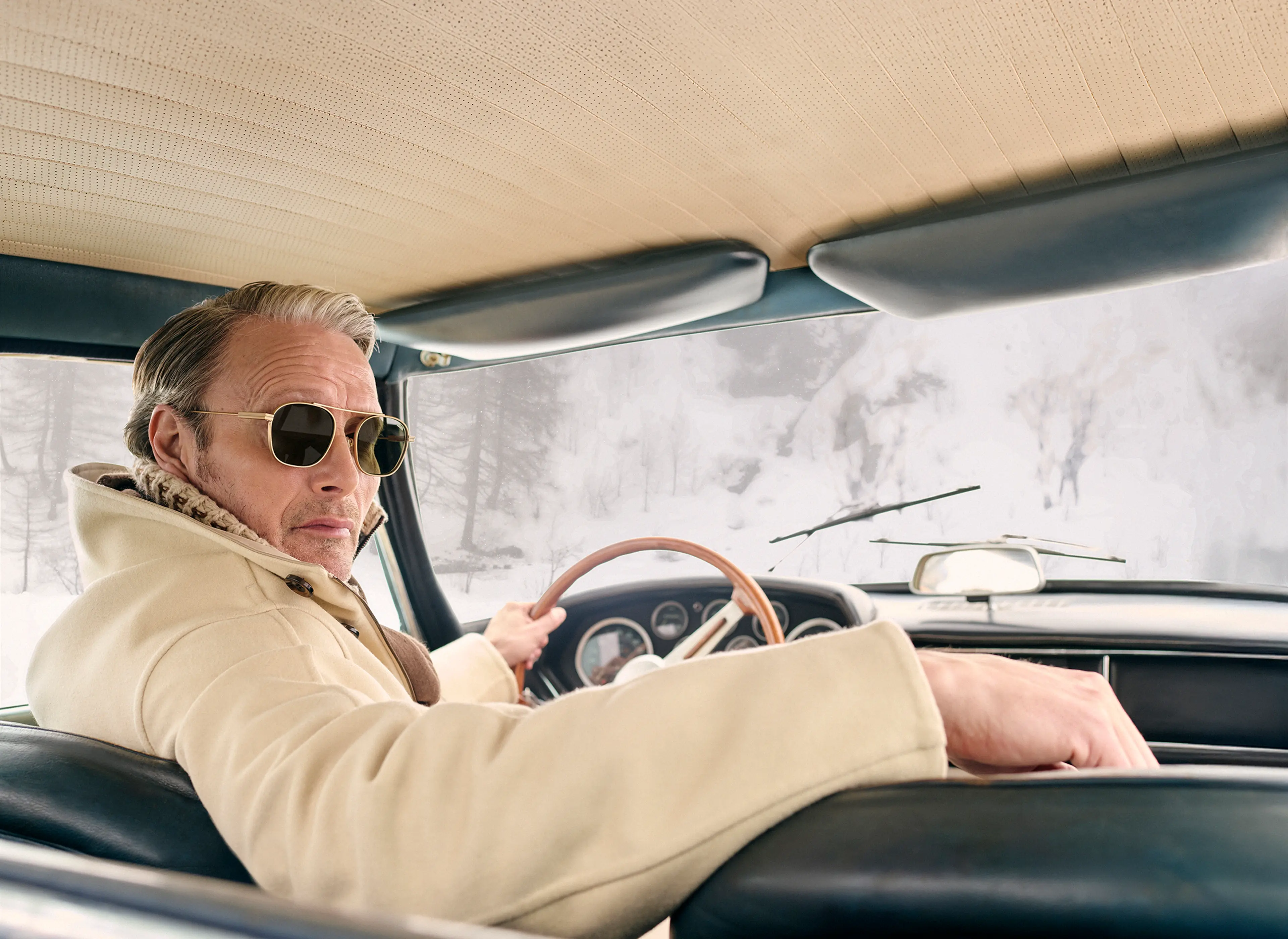 Mads Mikkelsen wearing a ZEGNA winter look featuring a ski suit.