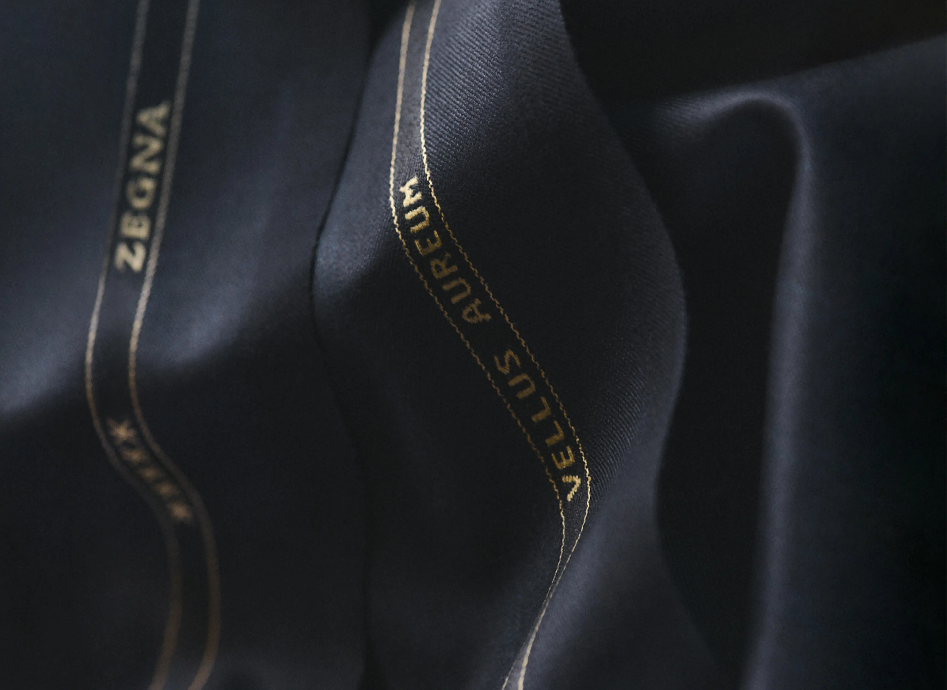 Detail of ZEGNA Vellus Aureum men's fabric with branding.
