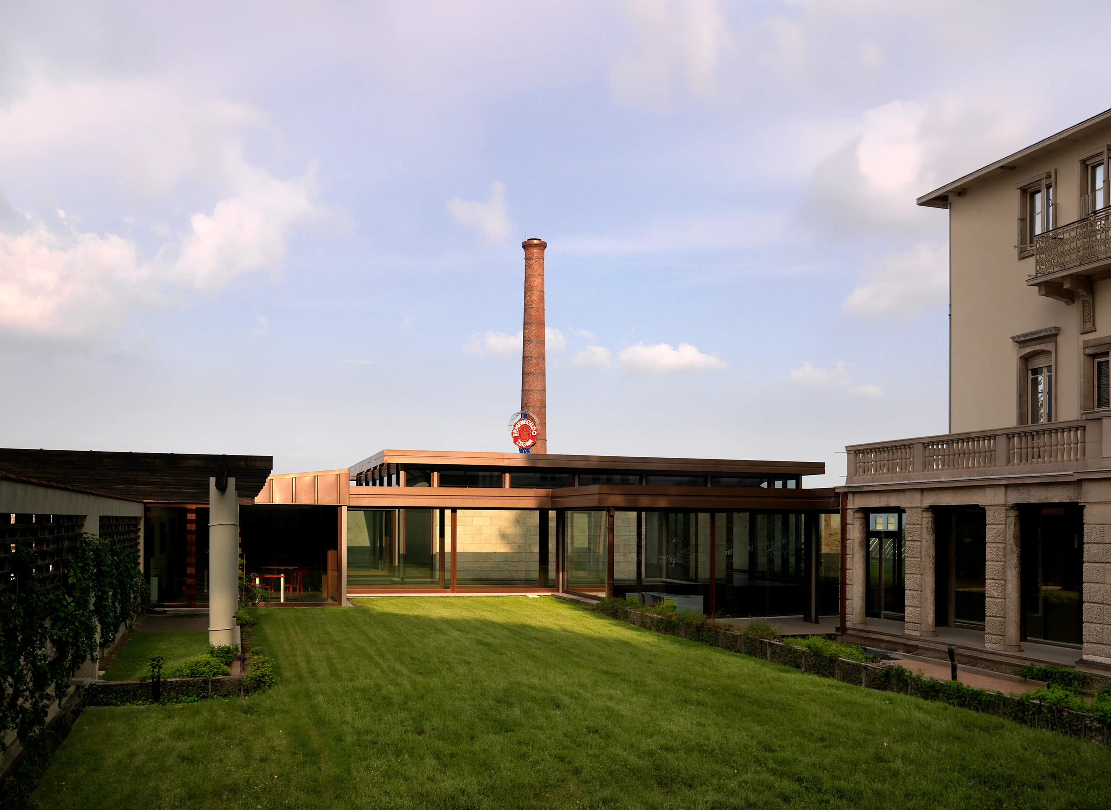 Architectural view of ZEGNA HQ with historic Lanificio ZEGNA chimney.