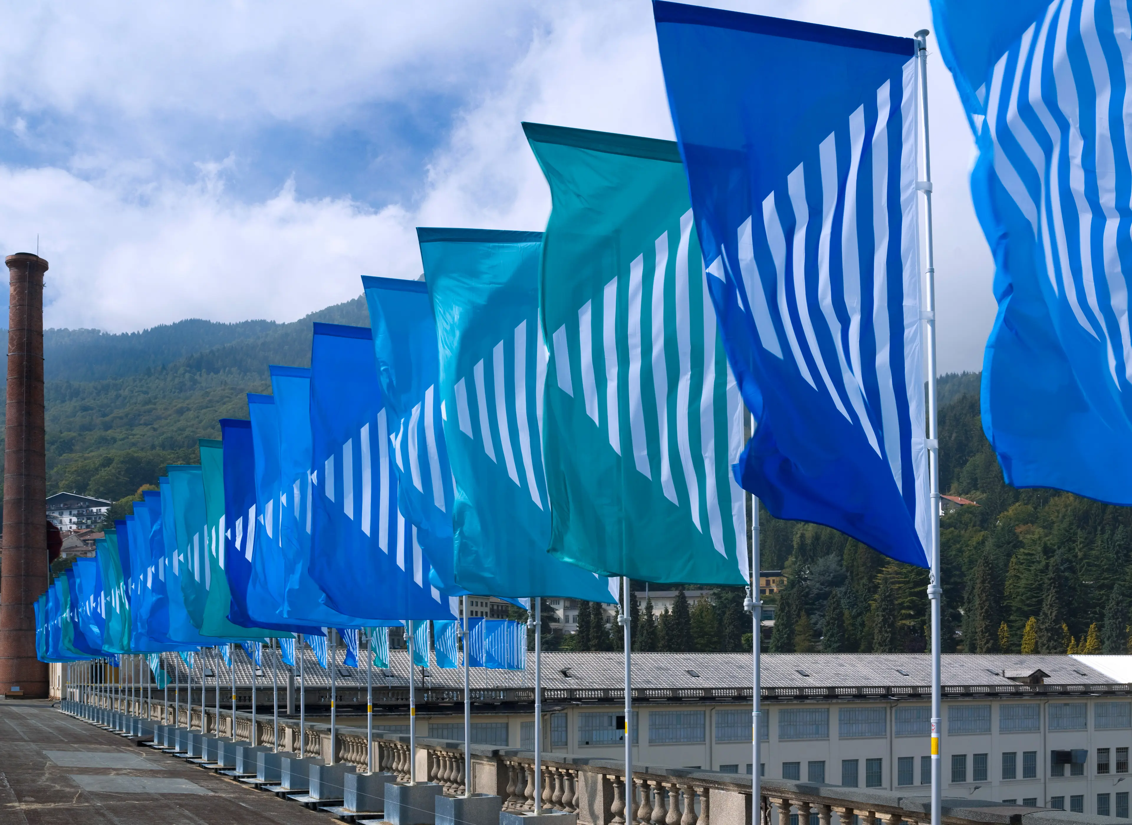 Lanificio ZEGNA and Art Basel installation with blue and green flags.