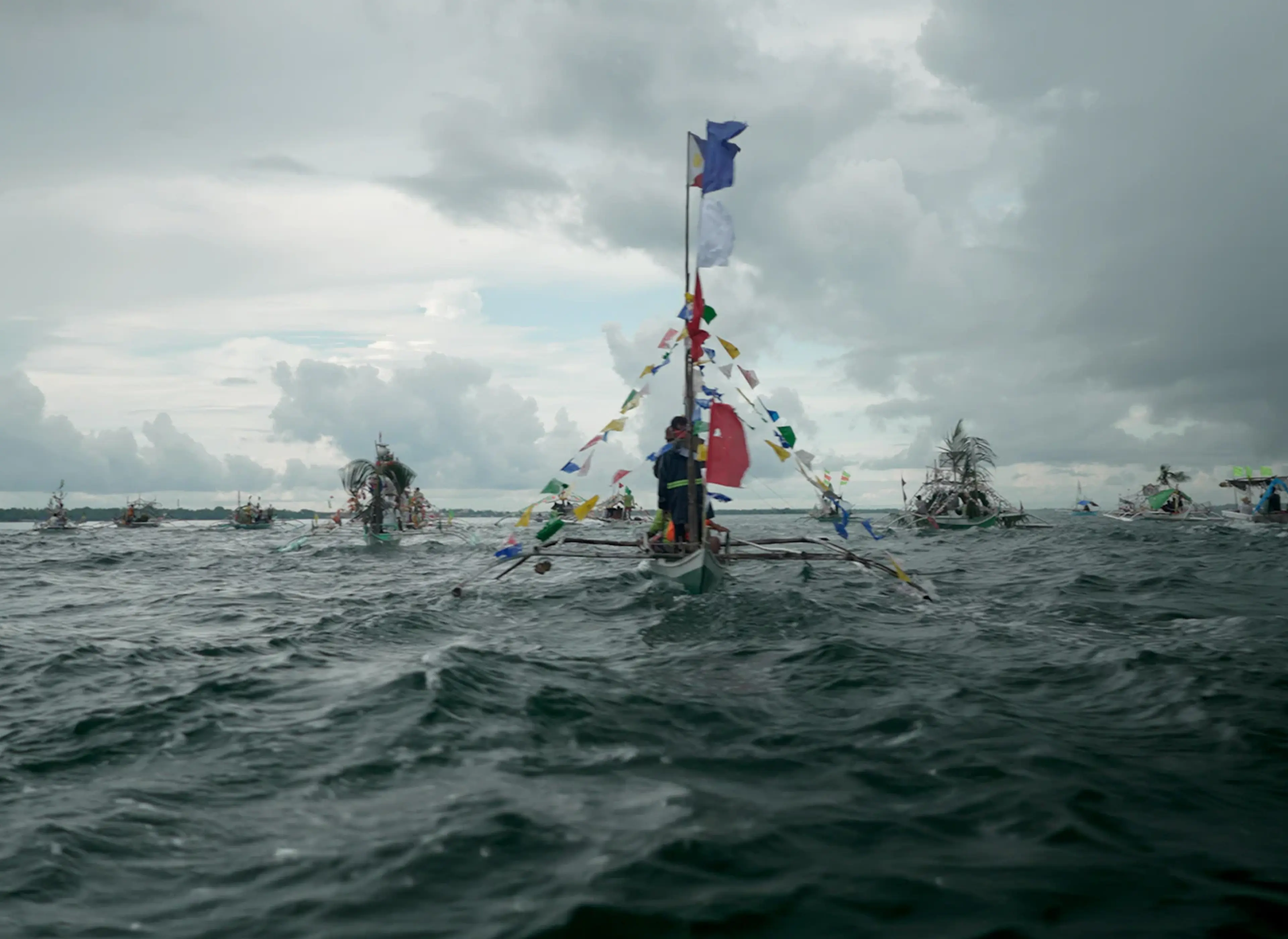 Fisherfolk, an artwork featuring a traditional fishing boat decorated with plastic waste to highlight ocean pollution.