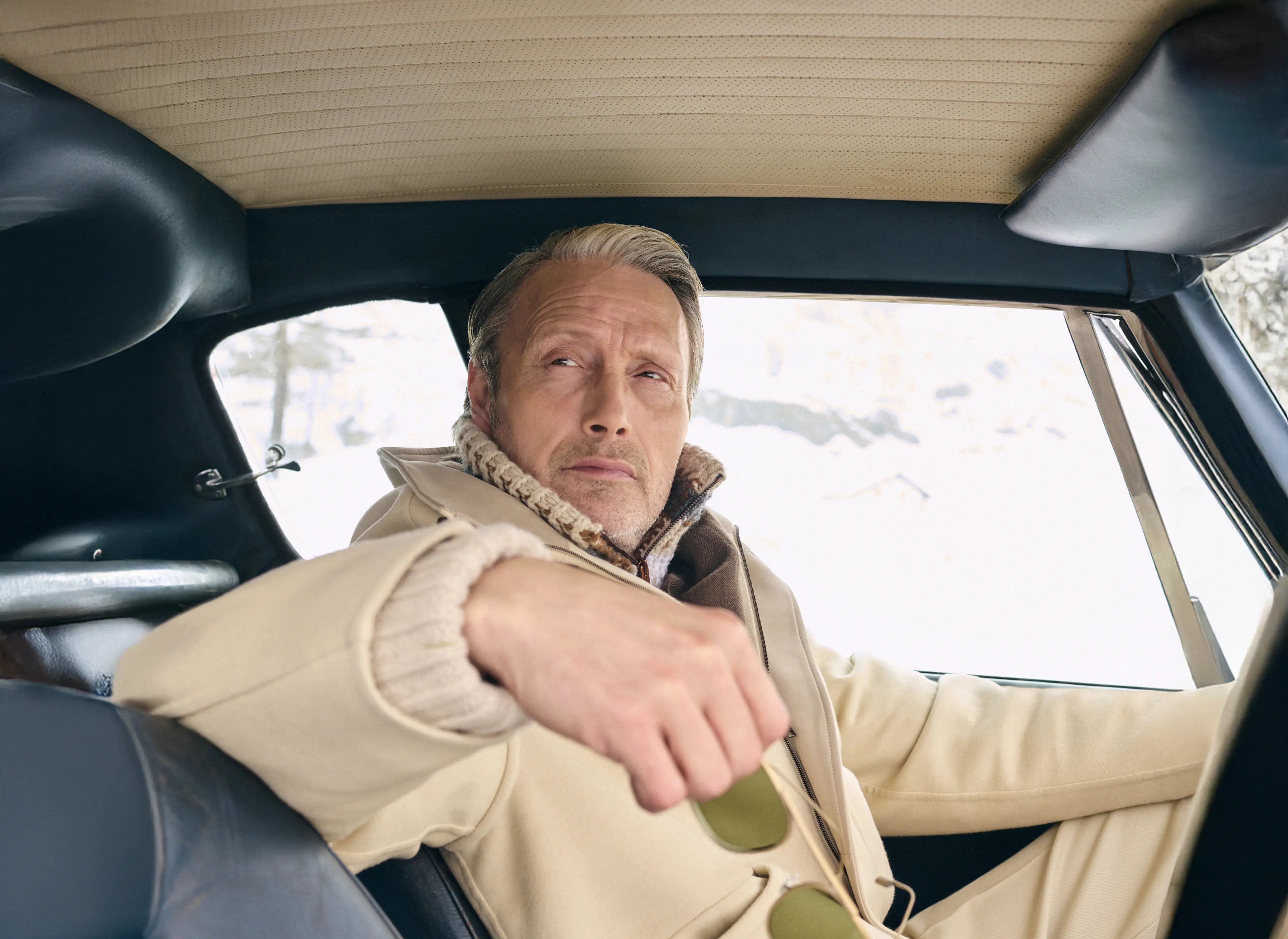 Mads Mikkelsen wearing a ZEGNA winter look featuring a ski suit.