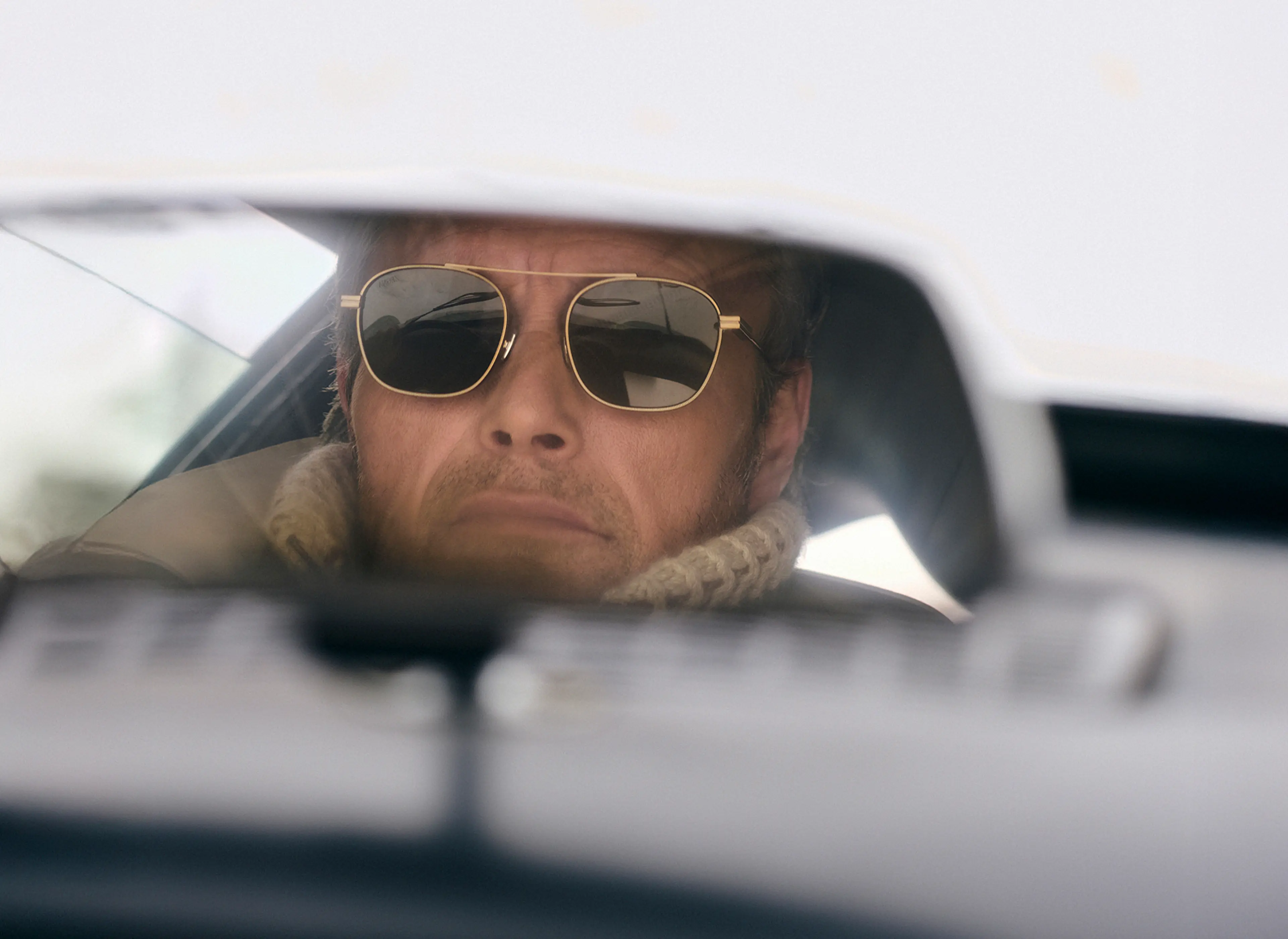 Close-up of Mads Mikkelsen in a ZEGNA winter look featuring sunglasses.