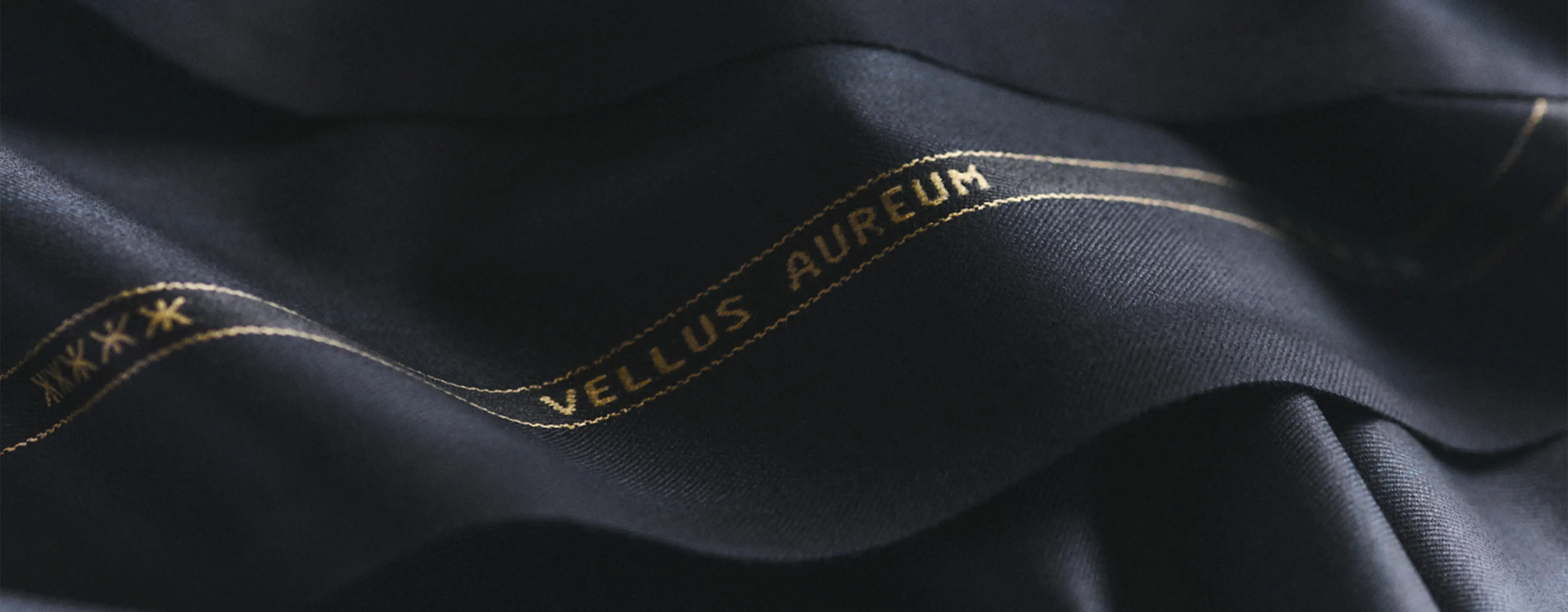 Detail of ZEGNA Vellus Aureum men's fabric with branding.