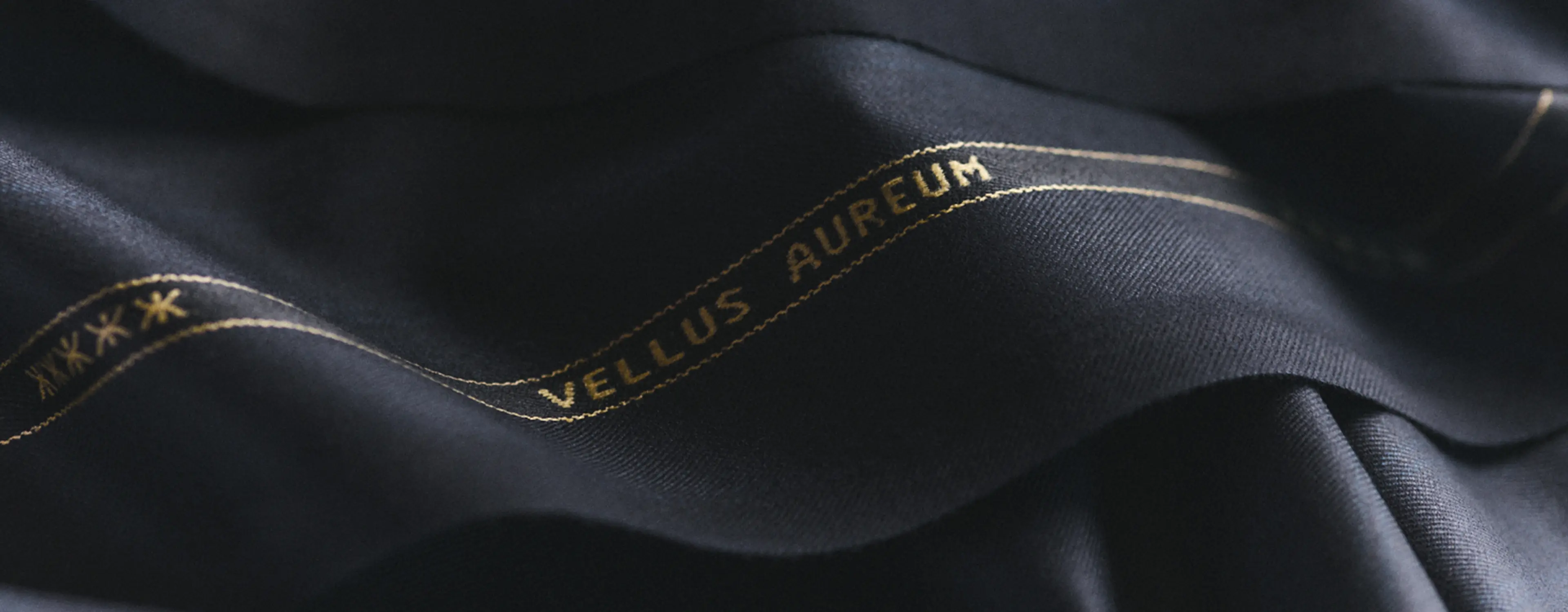 Detail of ZEGNA Vellus Aureum men's fabric with branding.