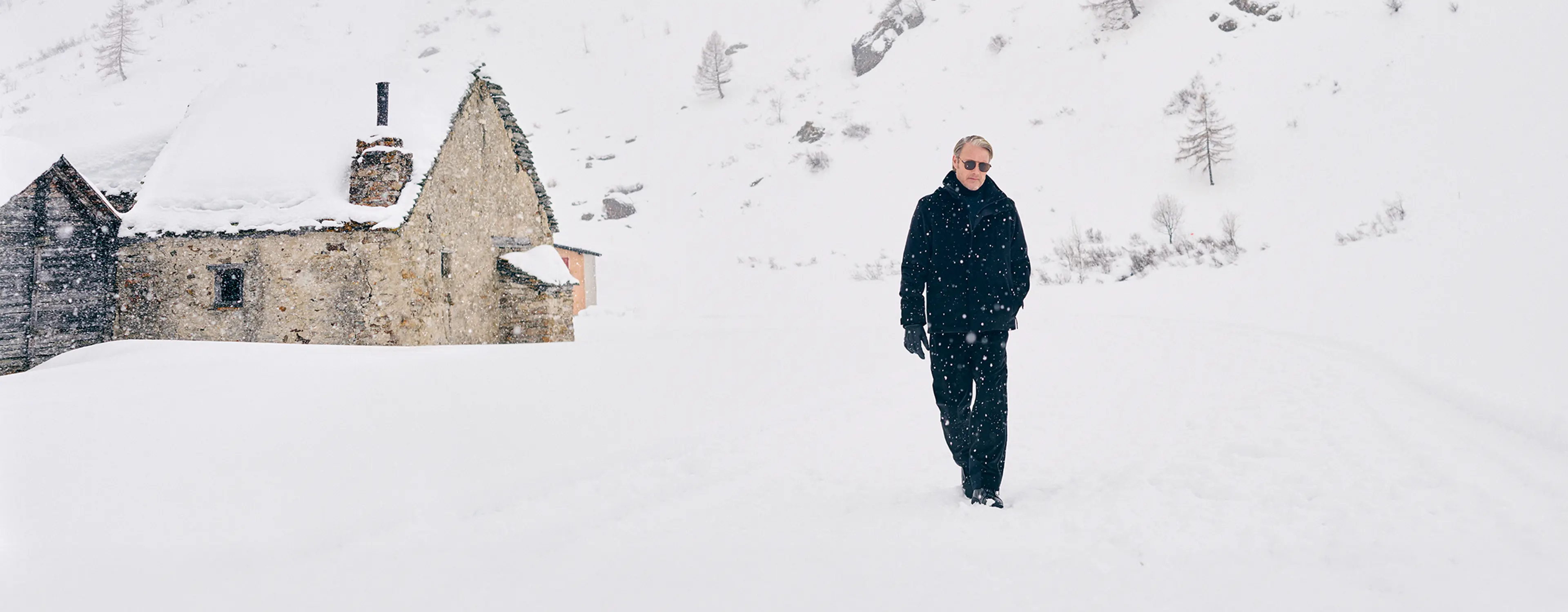 Mads Mikkelsen wearing a ZEGNA winter look featuring a ski suit.